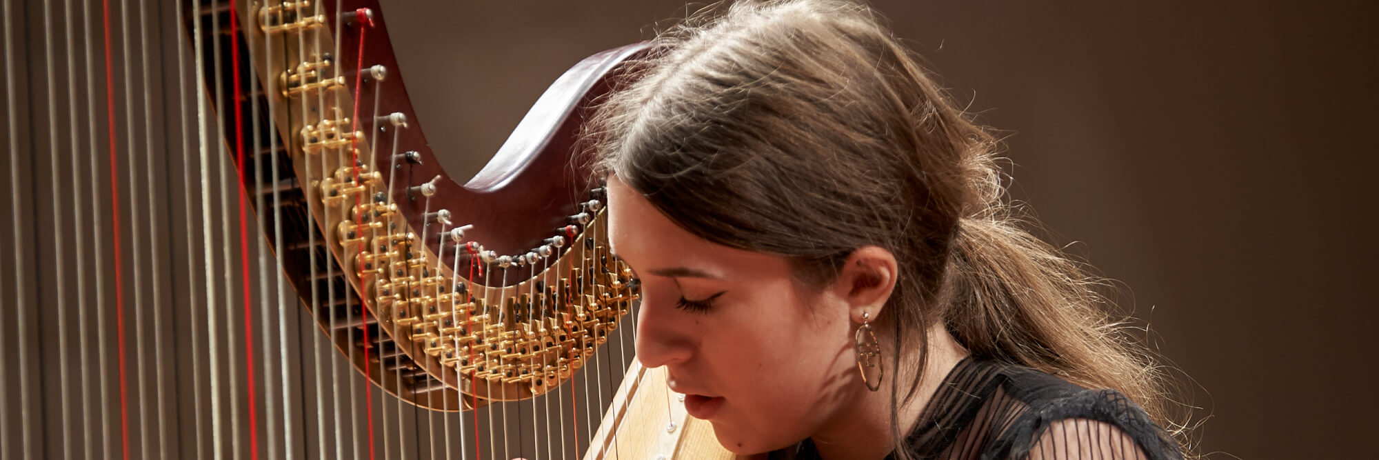 Pre-College student playing harp