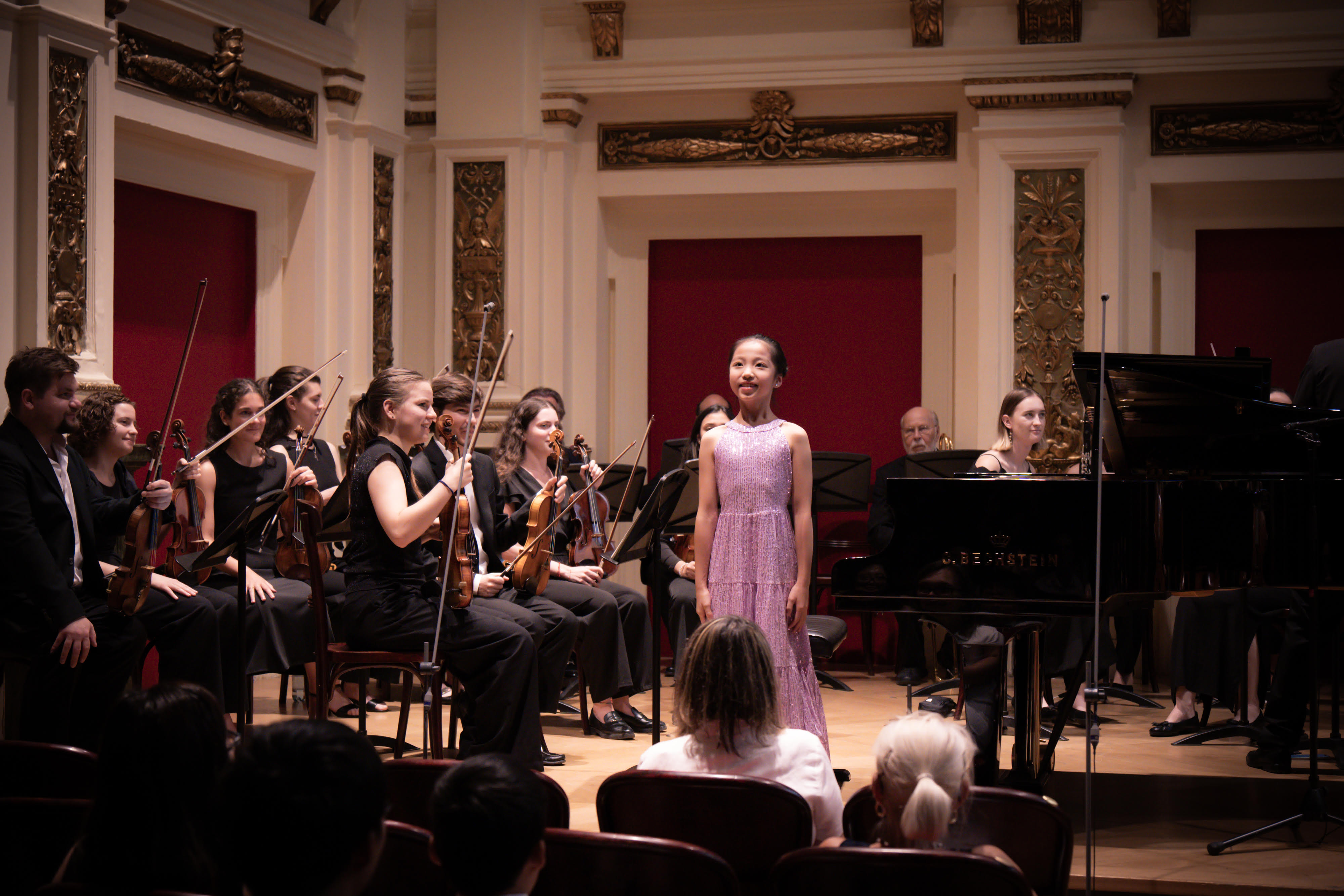 Pre-College student Arianna Lu playing piano for string orchestra