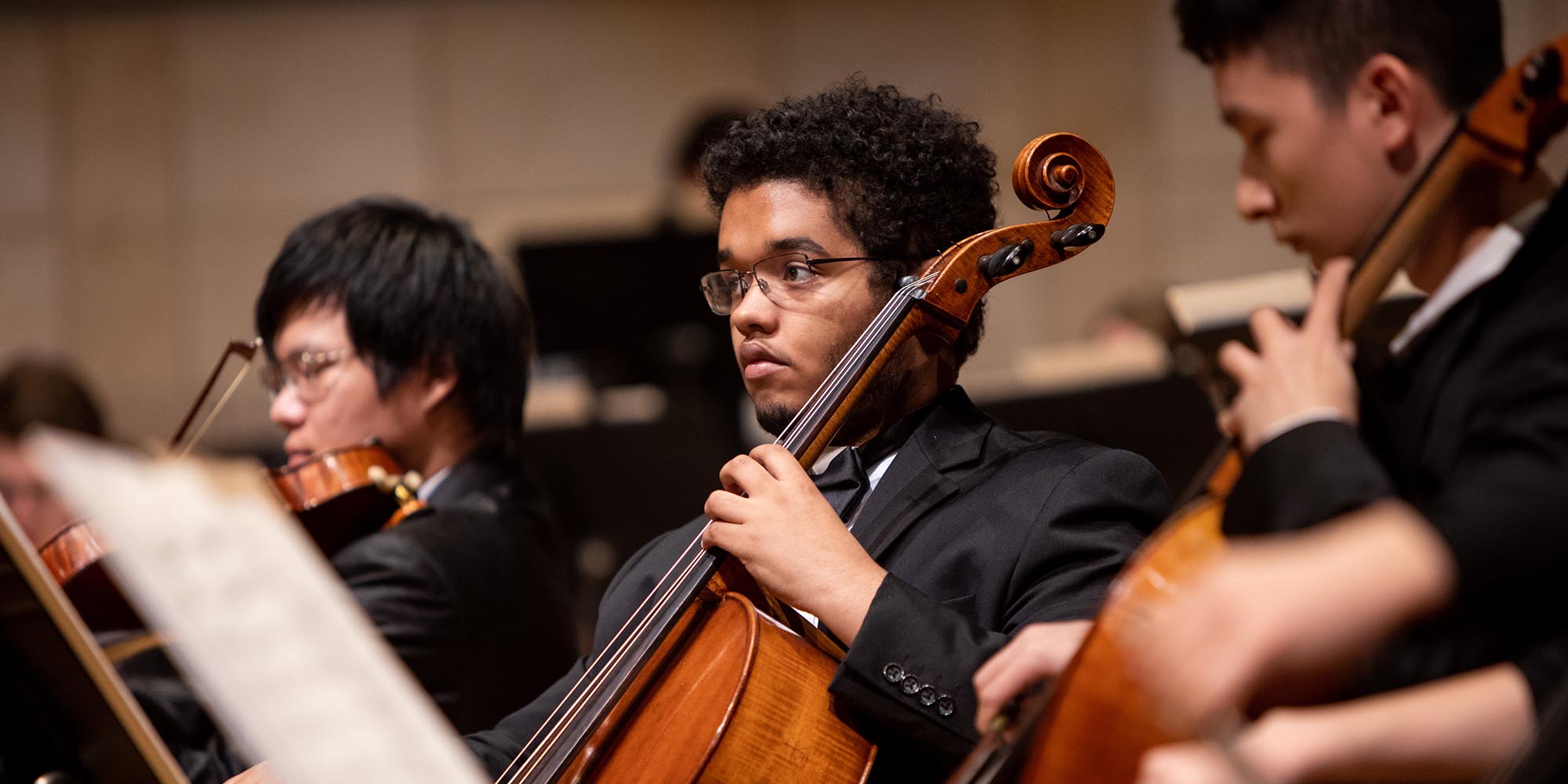 A SFCM student performing on the cello in the orchestra A SFCM student performing on the cello in the orchestra