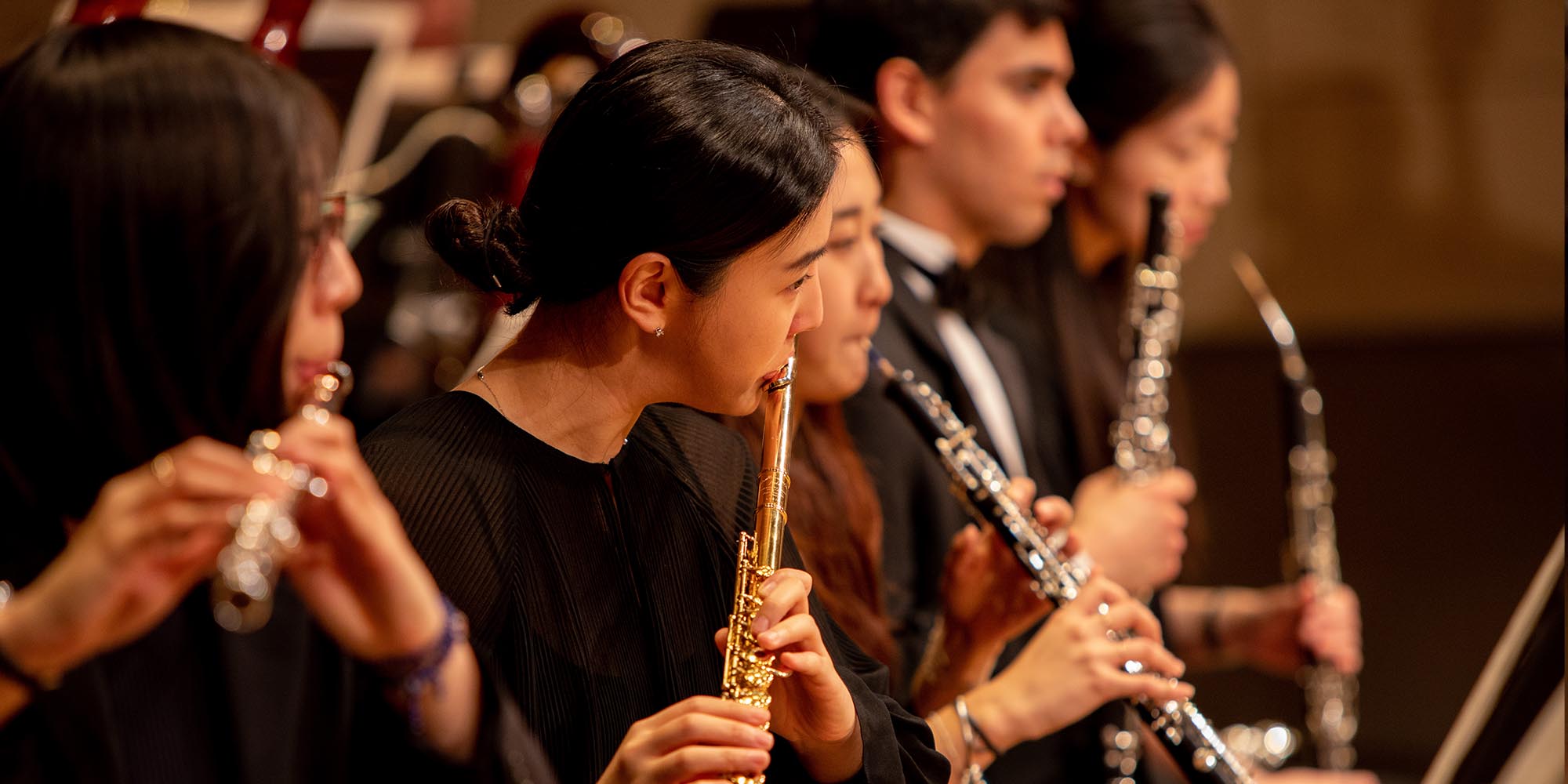 A SFCM student performing on the flute in the SFCM orchestra