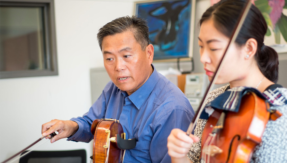 SFCM faculty teaching a student