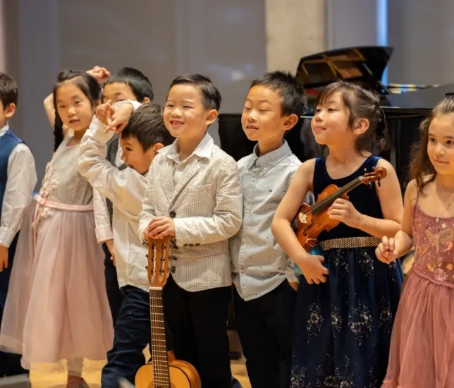 pre-college students lines up for bows after a recital
