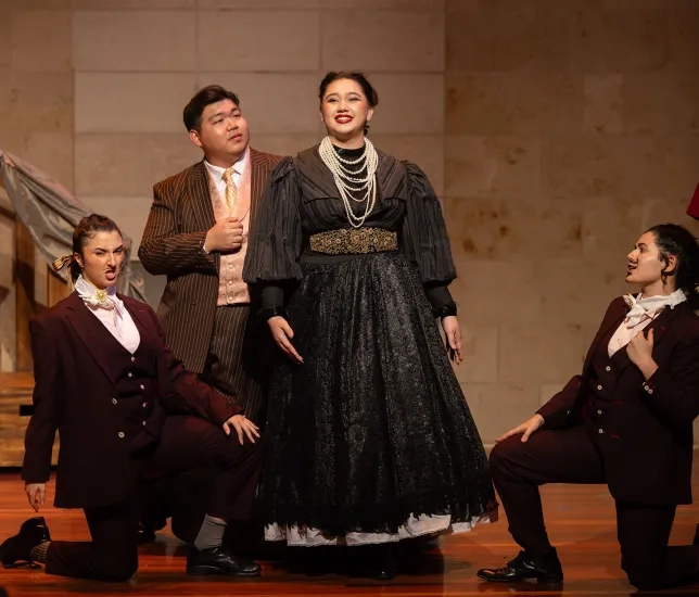Mumtoz Ochilova (center) performs as Hanna Glawari. 