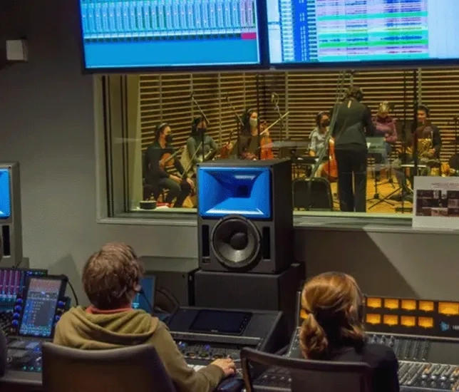 Two people inside one of SFCM's studios during a recording session.