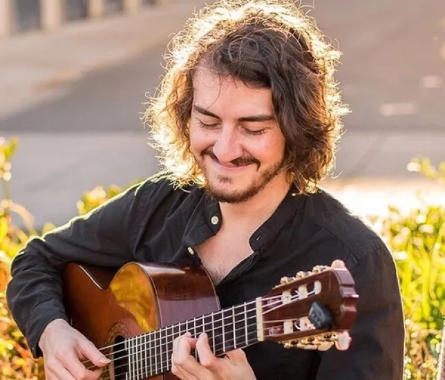 Student with Guitar Outside