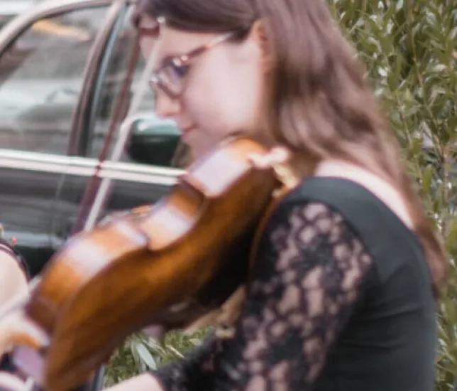 Student violinist performing music outside