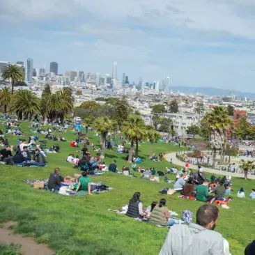 Dolores Park on a sunny day with people all over the grass