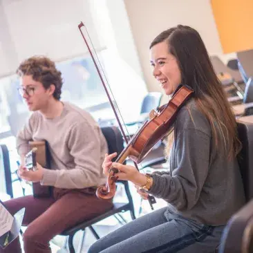 a guitarist and violinist in improv class