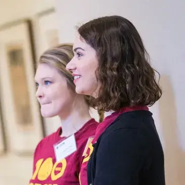 two students ready to greet newcomers