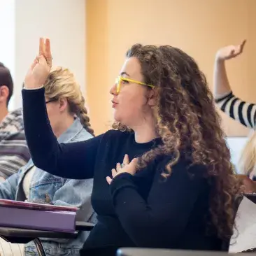 a student raises their hand in class