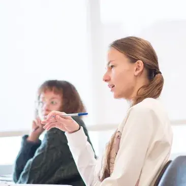 students in a classroom asking questions