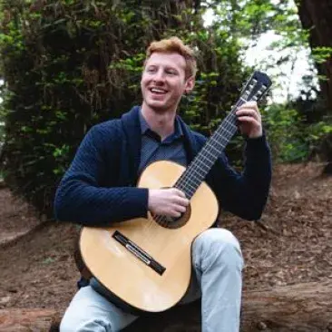 SFCM student playing guitar outside