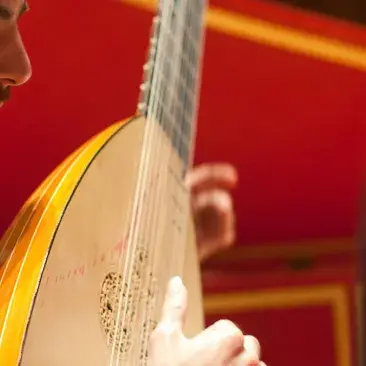 student playing historical instrument