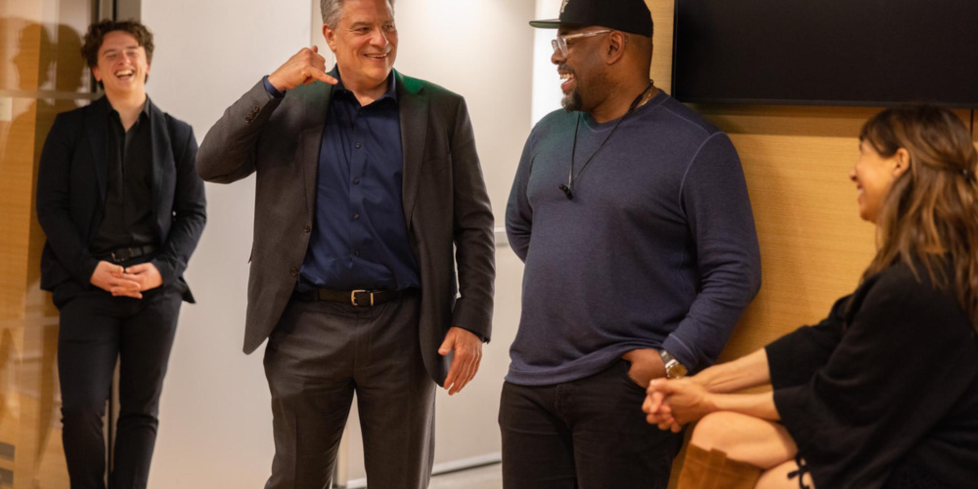 david stull makes a phone call gesture while looking at lara downes and christian mcbride