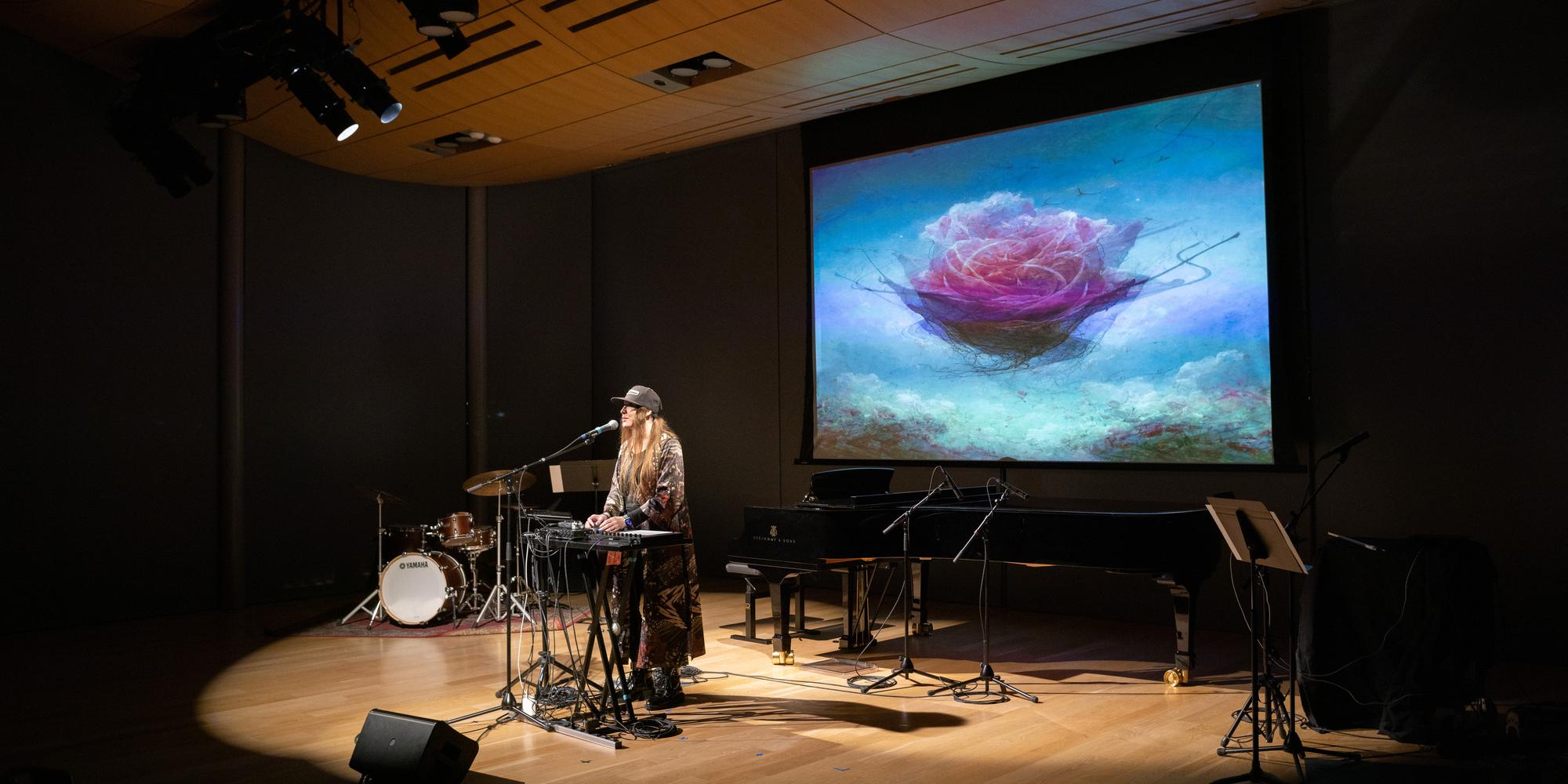 a student performs in front of a projection on electric equipment