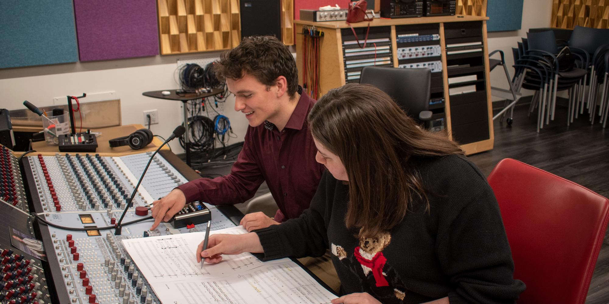two students look over a film score in a SFCM TAC studio