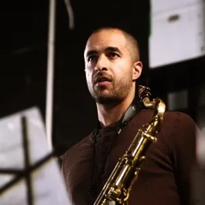 Tony peebles with his saxophone in front of a music stand