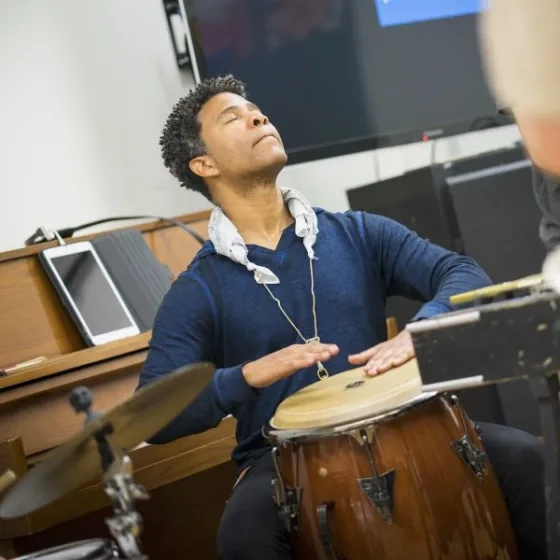 David Sánchez headshot playing the bongos