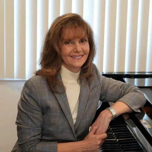 Lena Schuman headshot while sitting at piano