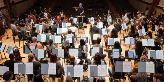 an orchestra rehearsal from the choir landing