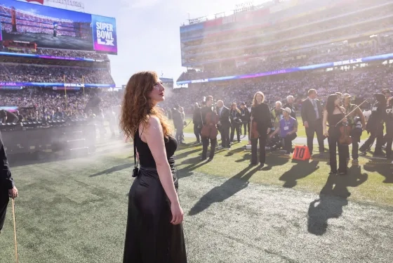 Alumna Alexandra Simpson and the ensemble prepares to perform.