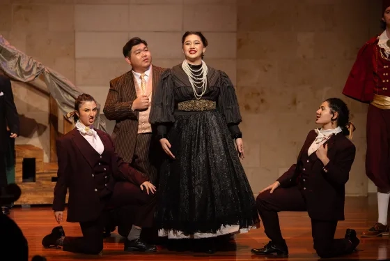 Mumtoz Ochilova (center) performs as Hanna Glawari. 