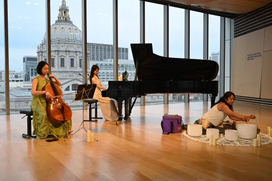 Cellist and organizer Zoe Lee performs with pianist Cesónia da Rosa and yoga instructor Pudji Lestari.