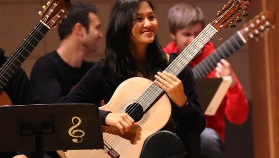 guitarists smiling in guitar ensemble