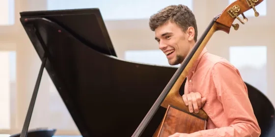 RJAM Knox Barber double bass in front of an open grand piano