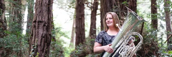 SFCM Student Playing Tuba in the forest