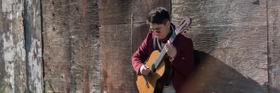 SFCM Student playing Guitar outside