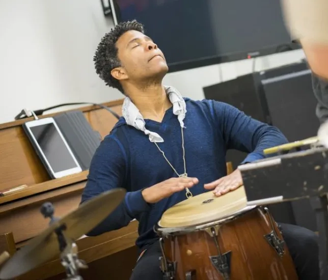 David Sánchez headshot playing the bongos
