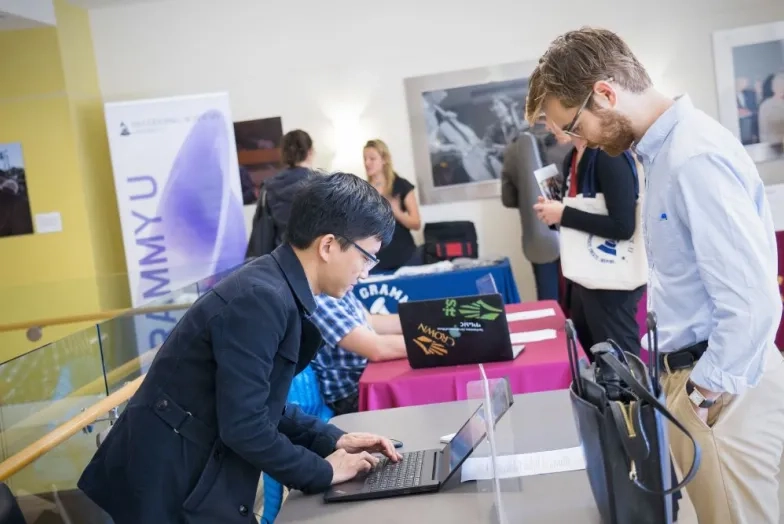 a student leans over a table at a job fair