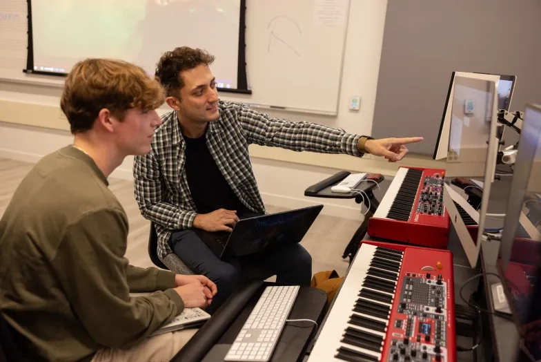 Rafe Axne (left) and Theo Popov (right) work in an SFCM studio.