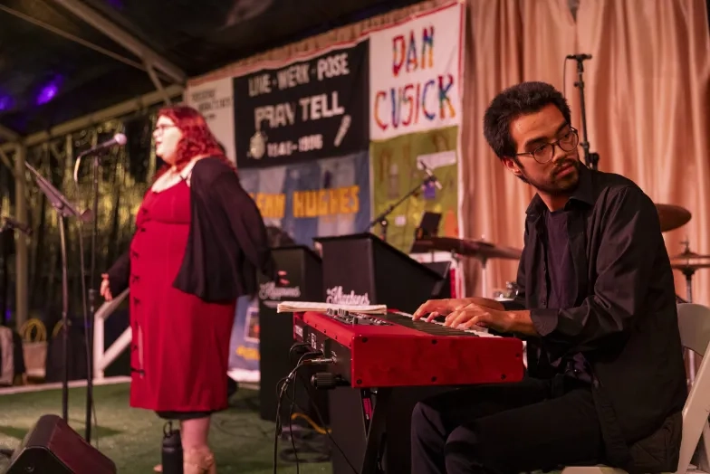 Students Catalina Hill (left) and Emmett Van Leer (piano) perform at the 2025 Light in the Grove gala (Credit: Onyx &amp; Ash Photography).