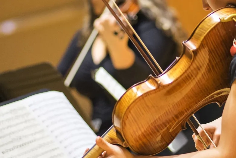 A close shot of a violist playing music in a chamber ensemble