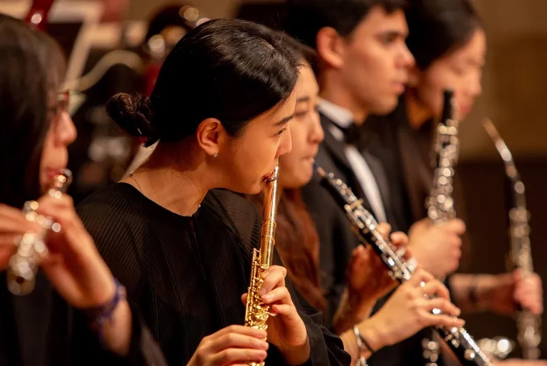 A SFCM student performing on the flute in the SFCM orchestra