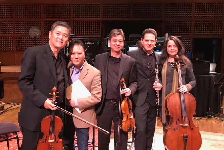 Performers holding string instruments