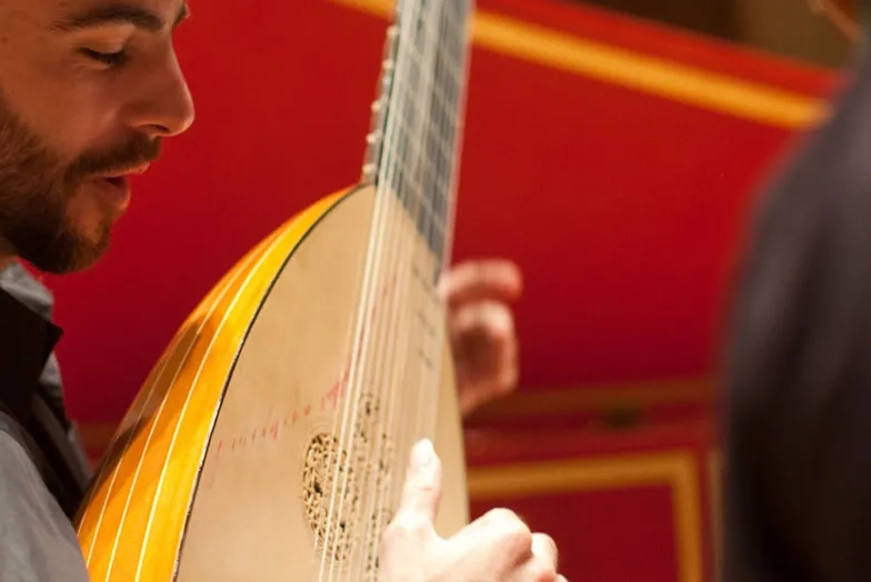 student playing historical instrument