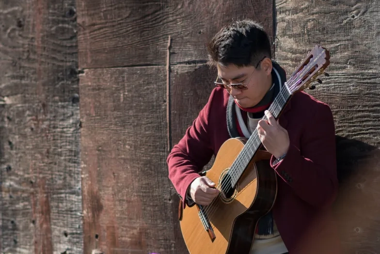 SFCM Student playing Guitar outside