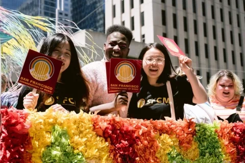 students on the pride float smiling