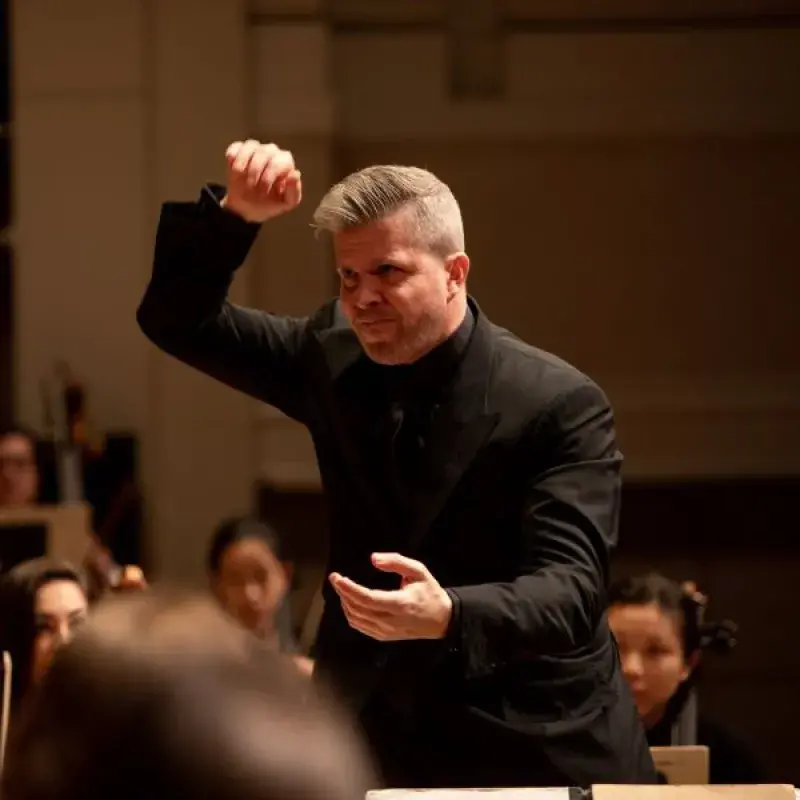 edwin outwater conducting during a performance, he is about to give a strong downbeat