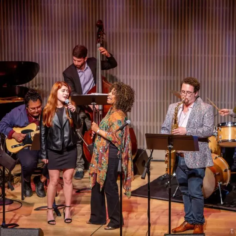 students perform with teachers in a jazz ensemble